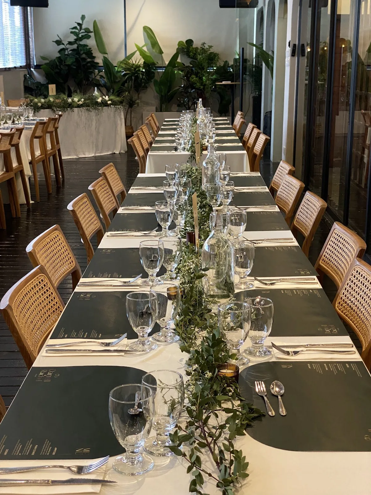 Wedding long table with greenery and glassware