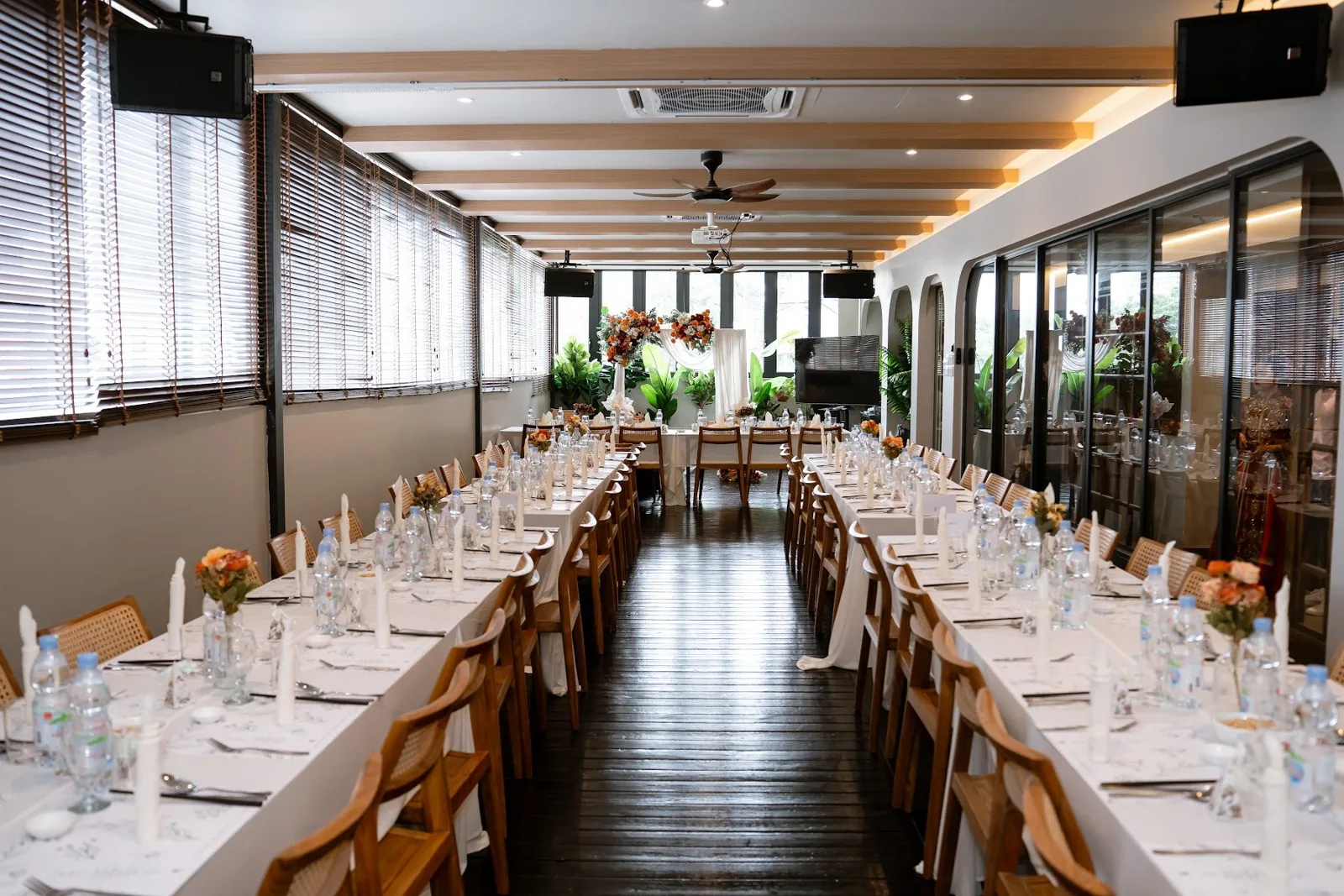 Monstera Hall with long wedding tables